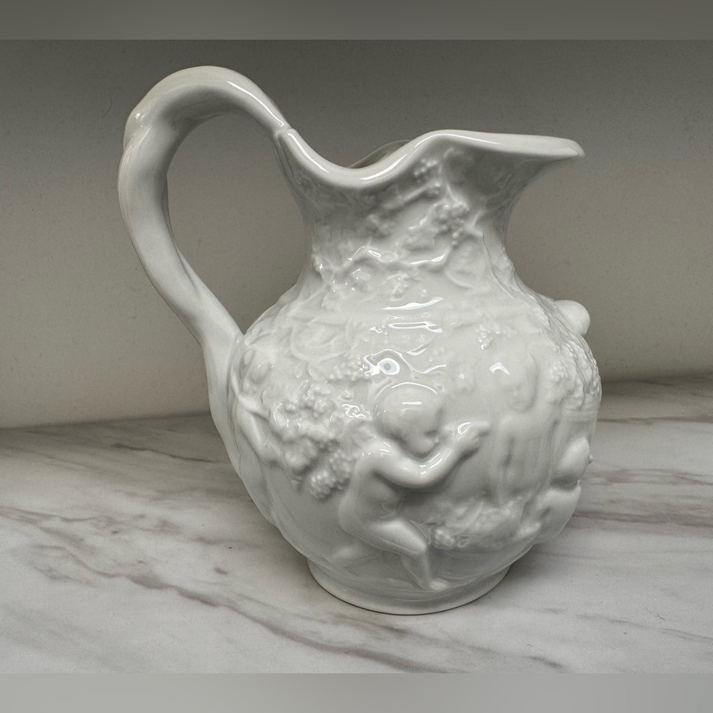 Vintage white decorative wine jug by Furstenberg of West Germany with cherubs.